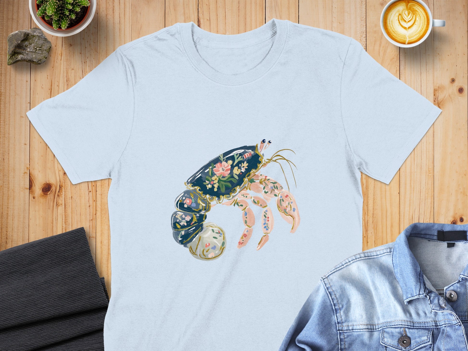 Light blue t-shirt with a floral-patterned hermit crab design.