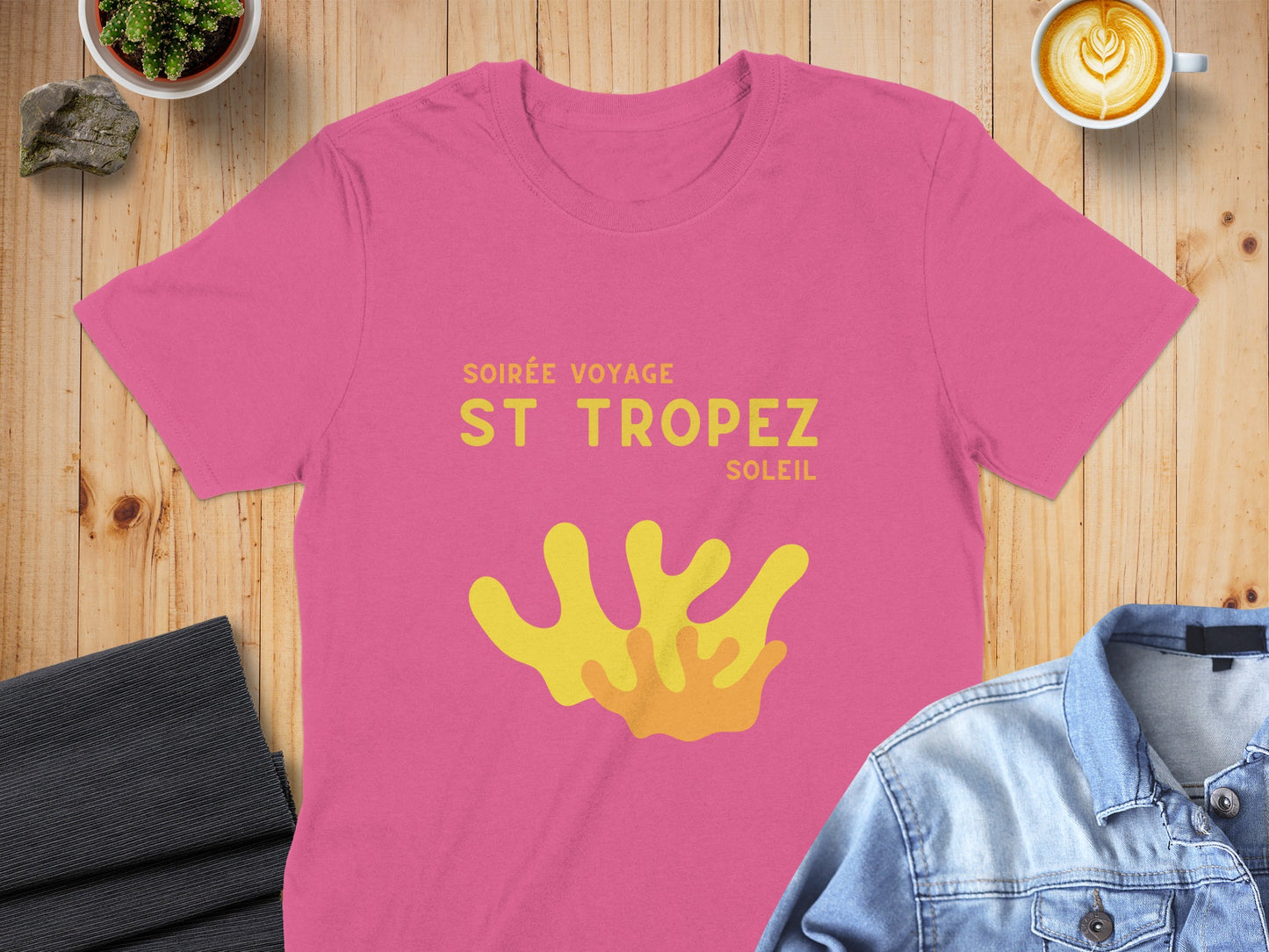 Pink t-shirt with "Soirée Voyage St Tropez Soleil" and yellow coral graphic.
