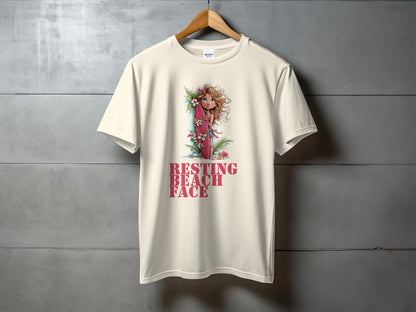 Cream t-shirt with "RESTING BEACH FACE" and a surfing fairy illustration.