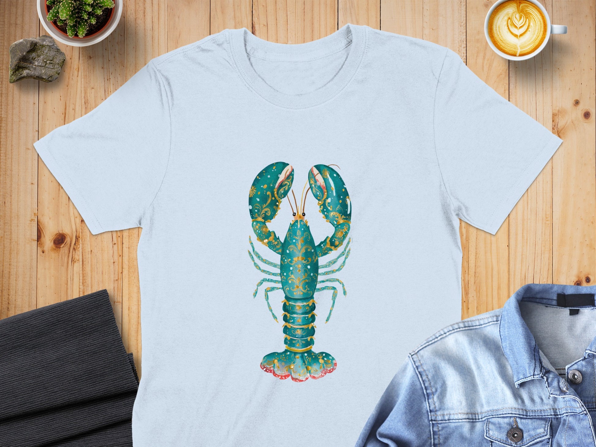 Light blue t-shirt with a stylized turquoise lobster design.
