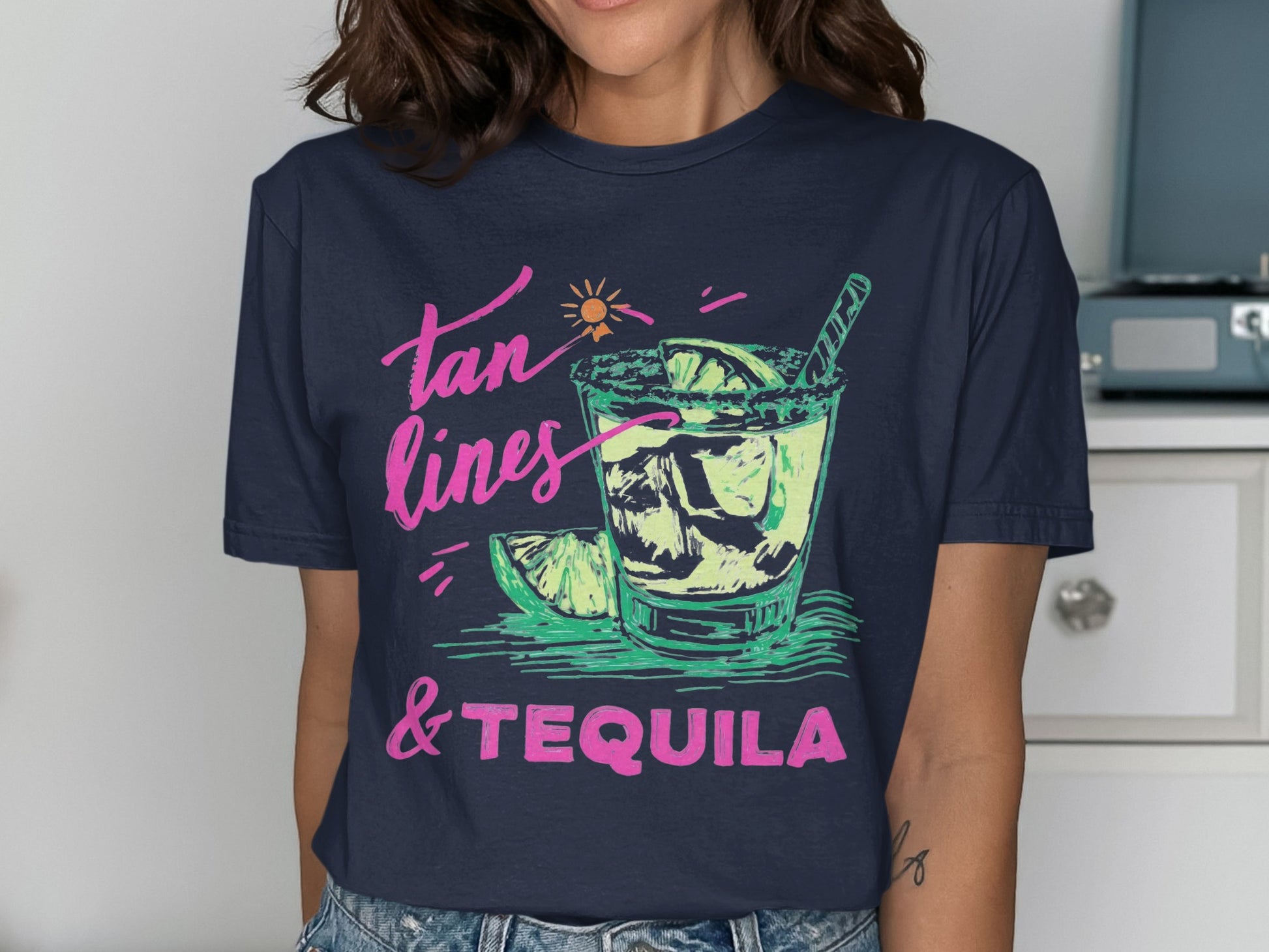 T-shirt graphic: "tan lines & tequila" text with a drink and lime wedges.