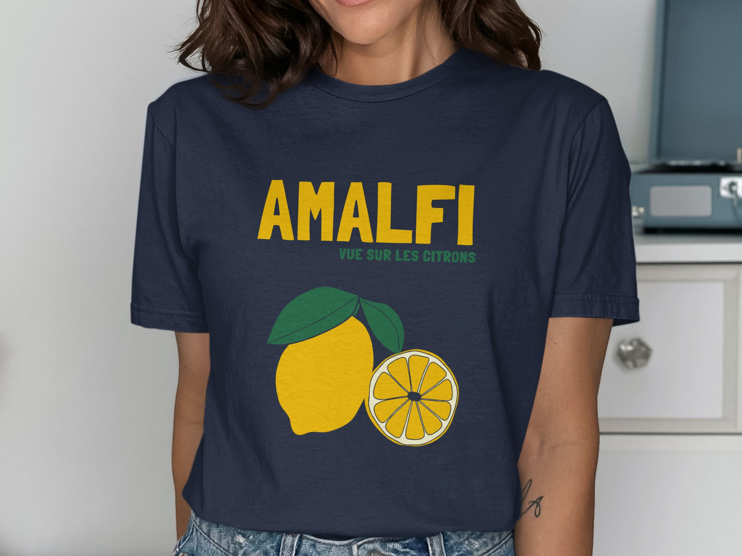 Navy t-shirt with yellow text "AMALFI" and lemon illustration.