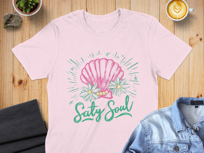 Pink t-shirt with a pink seashell, daisies, and "Salty Soul" text.