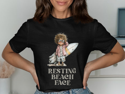 T-shirt with graphic of a boy with a surfboard, text reads "RESTING BEACH FACE".