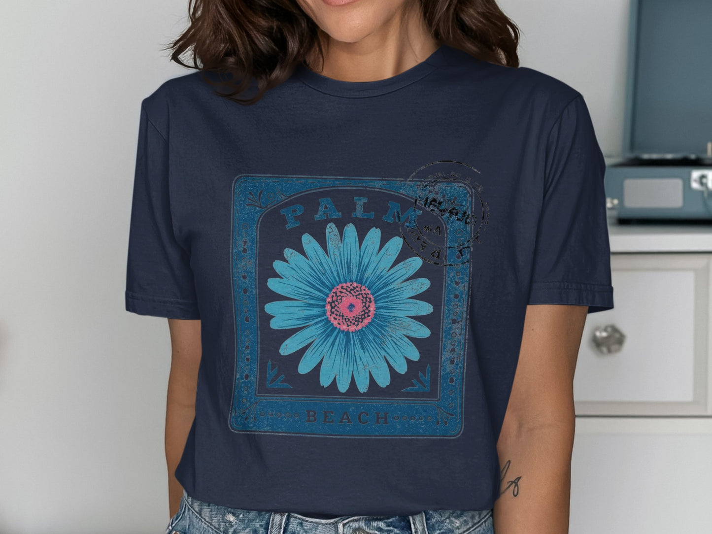 Dark blue t-shirt with a distressed blue daisy and "Palm Beach" text.