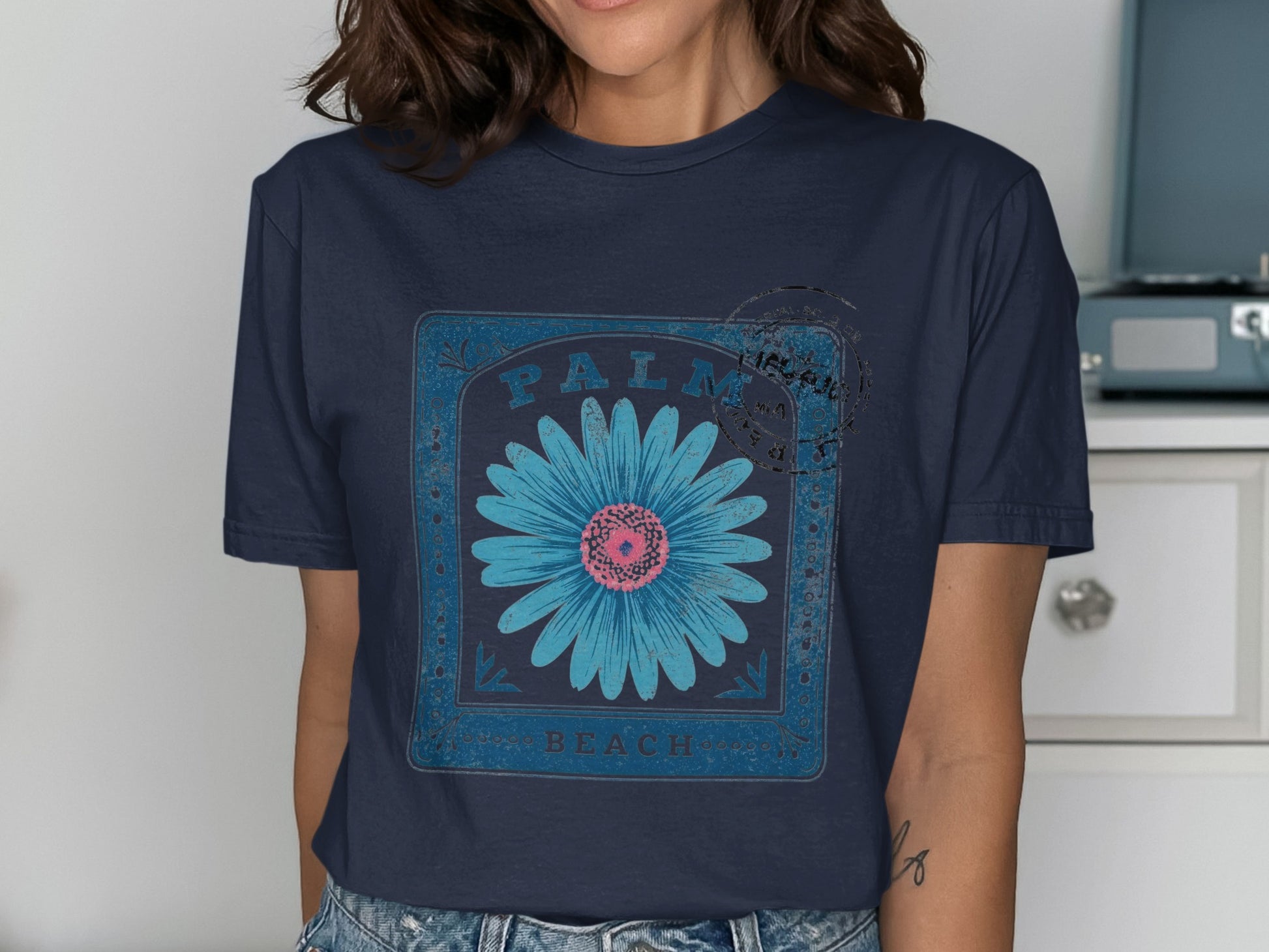Dark blue t-shirt with a distressed blue daisy and "Palm Beach" text.