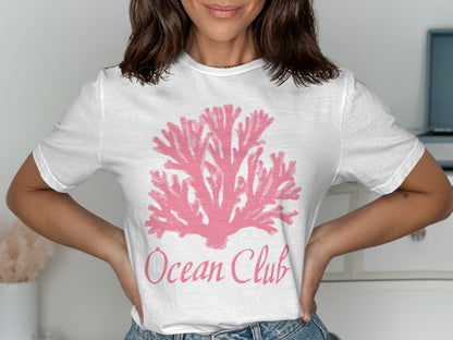White t-shirt with pink coral graphic and "Ocean Club" text.
