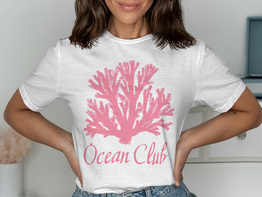 White t-shirt with pink coral graphic and "Ocean Club" text.