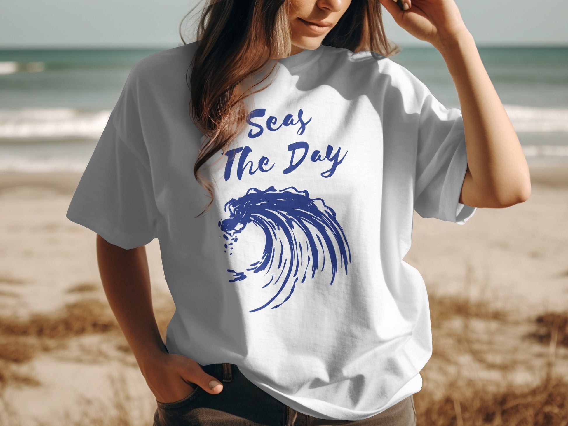 White t-shirt with blue wave graphic and "Seas The Day" text.