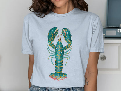 Light blue t-shirt with a stylized teal lobster and gold accents.