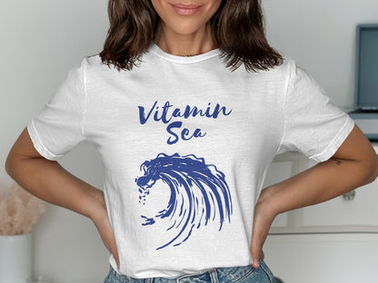 White t-shirt with blue "Vitamin Sea" text and a crashing wave graphic.