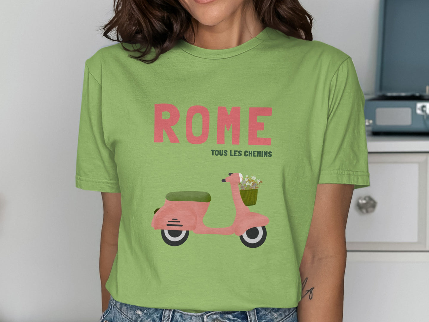 Green t-shirt with "ROME TOUS LES CHEMINS" and pink scooter illustration.