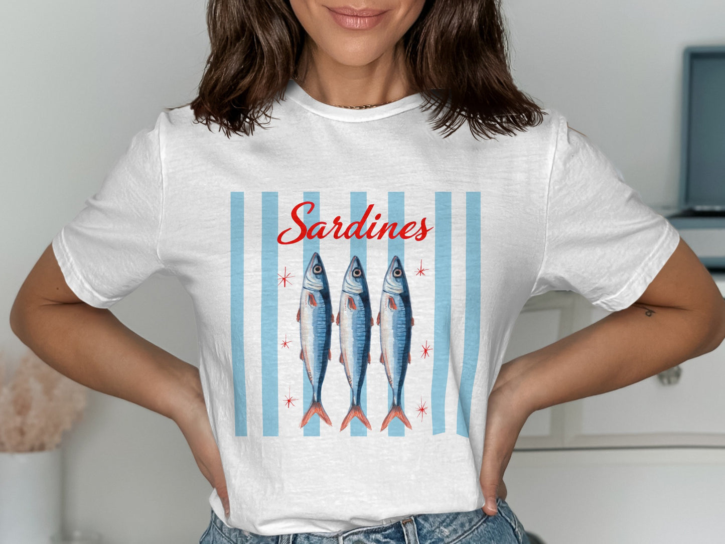 White t-shirt with "Sardines" text and three stylized fish.