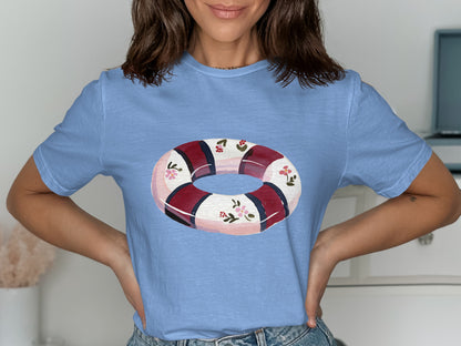 Blue t-shirt with a watercolor life preserver featuring red stripes and pink flowers.