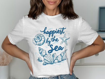 White t-shirt with blue "Happiest by the Sea" text and ocean shell graphics.