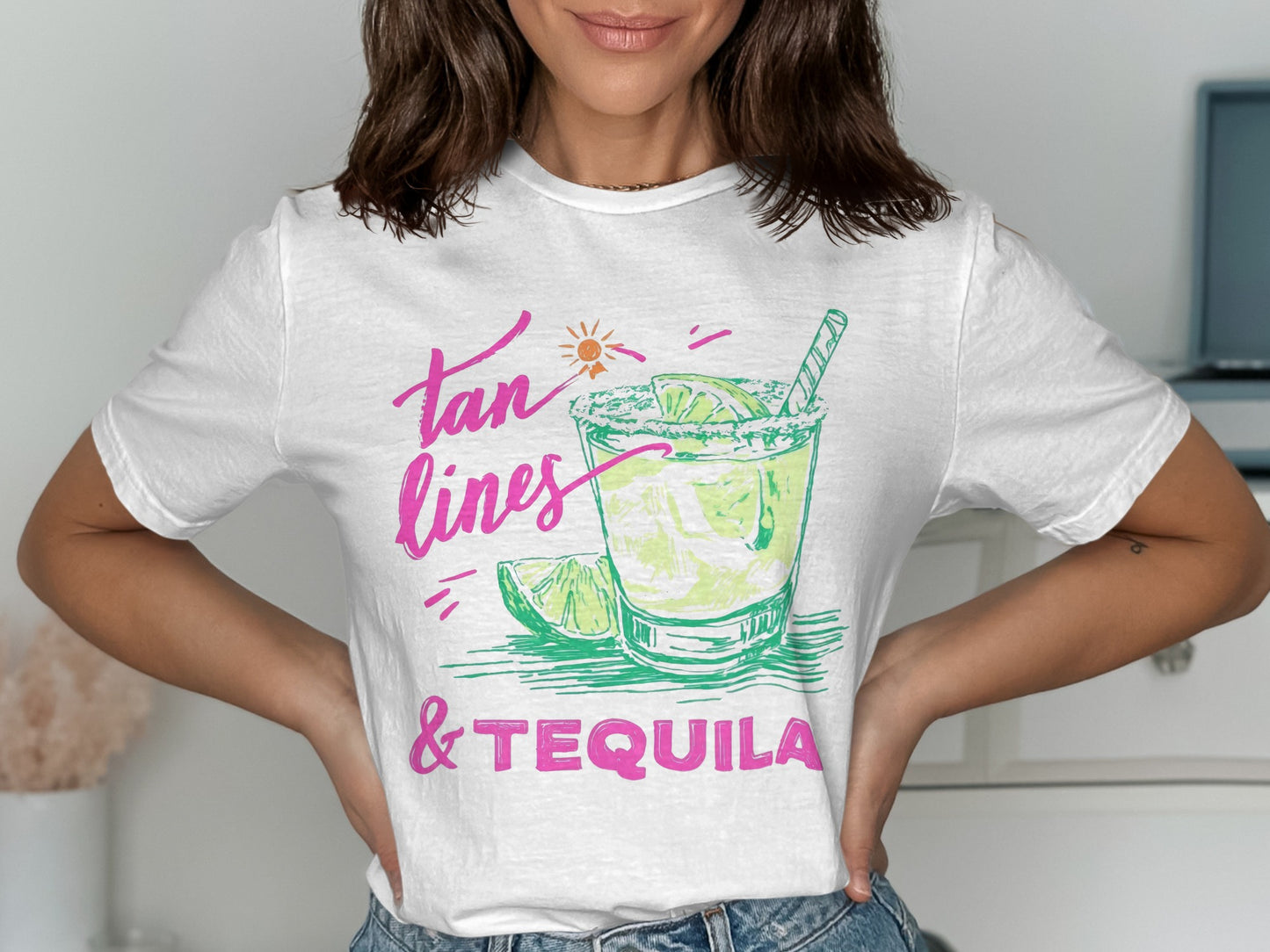 White t-shirt with "tan lines & tequila" text and cocktail graphic.