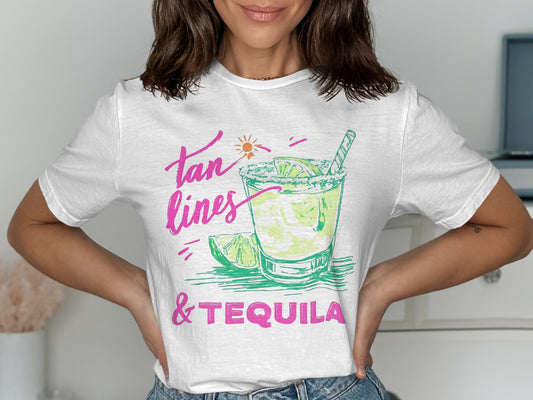 White t-shirt with "tan lines & tequila" text and cocktail graphic.