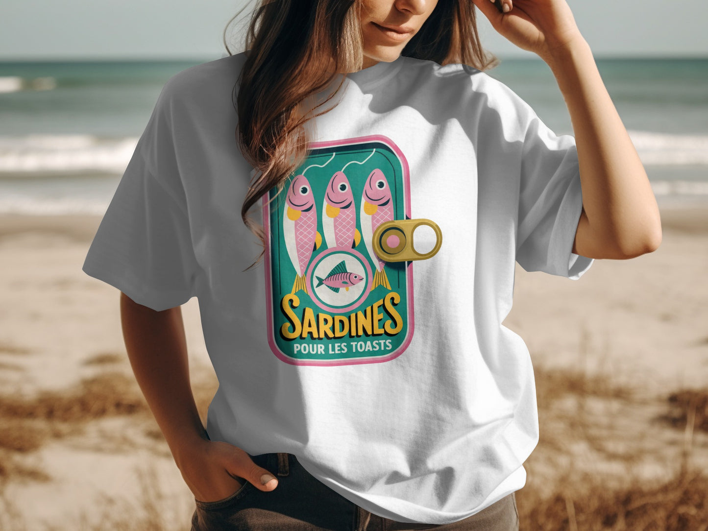 White t-shirt featuring a graphic of a sardine can labeled "Sardines Pour Les Toasts".