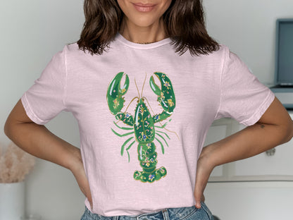 Light pink t-shirt with a stylized green lobster graphic and floral accents.