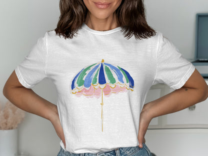 White t-shirt with a colorful umbrella graphic and scalloped pink border.
