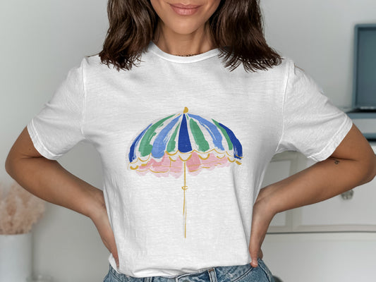 White t-shirt with a colorful umbrella graphic and scalloped pink border.