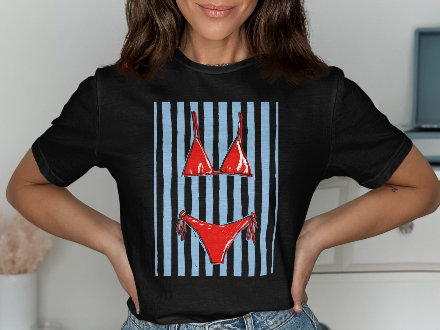Black t-shirt with a red bikini graphic over blue and light blue stripes.