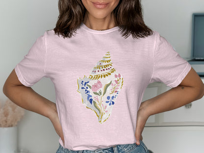 Pink t-shirt with floral seashell graphic.