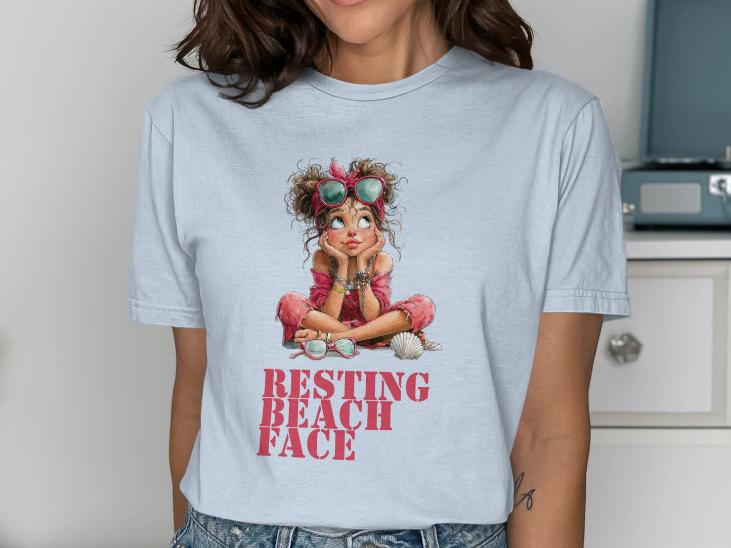 Light blue t-shirt with cartoon girl and "Resting Beach Face" text.
