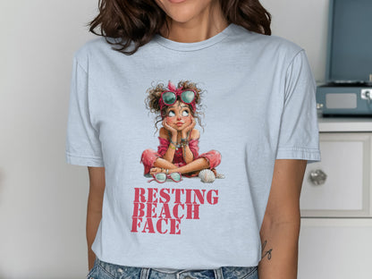 Light blue t-shirt with cartoon girl and "Resting Beach Face" text.