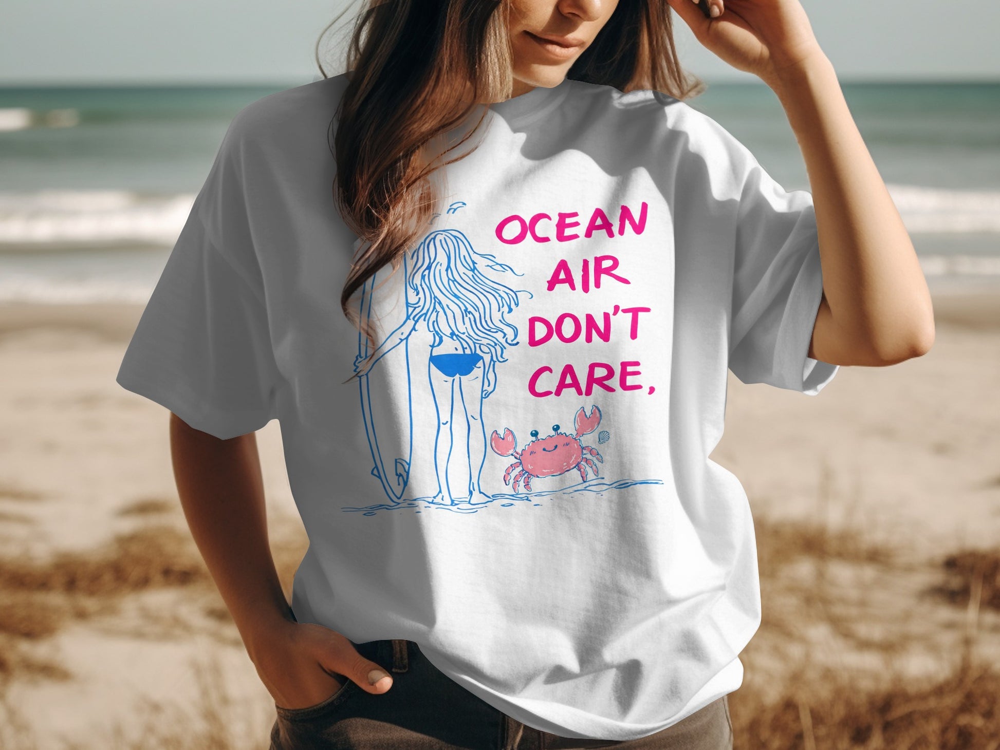 White t-shirt with "OCEAN AIR DON'T CARE" and a cartoon crab.
