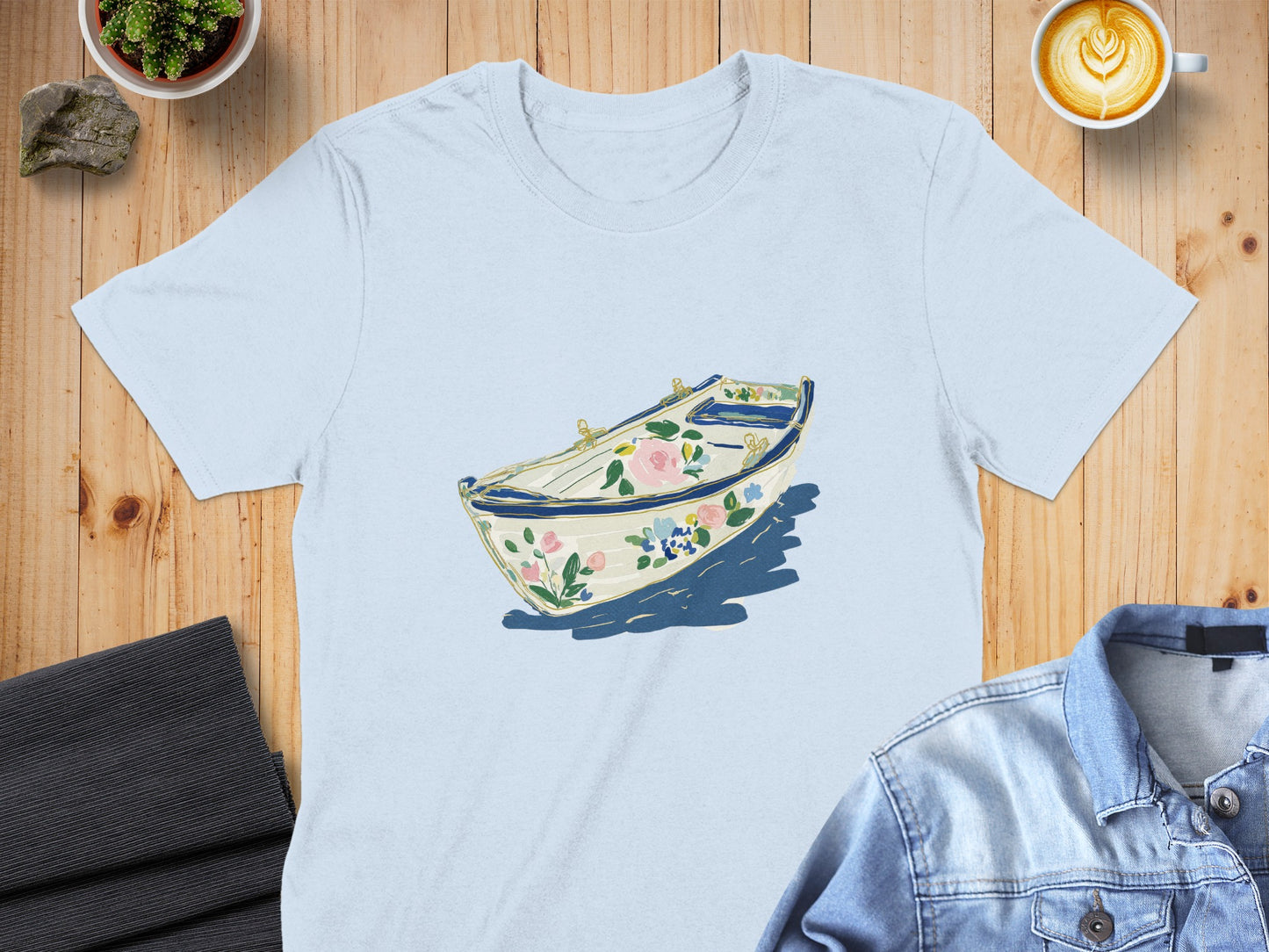 Light blue t-shirt with a floral boat illustration.