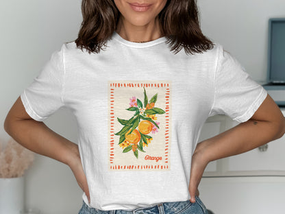 White t-shirt with a botanical illustration of an orange branch.