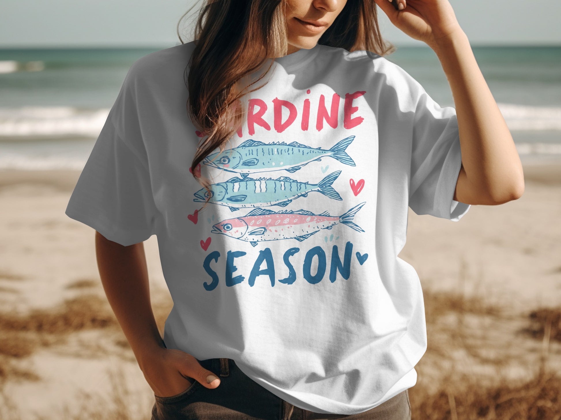 White t-shirt with cartoon sardines and "Sardine Season" text.