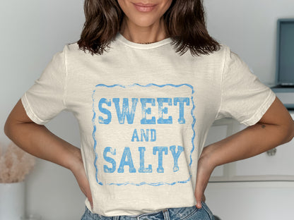Cream t-shirt with blue "SWEET AND SALTY" text in distressed font.