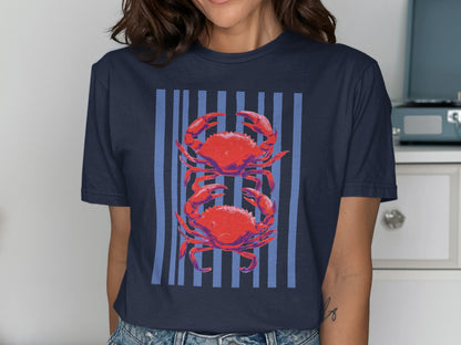 T-shirt featuring two red crabs on a background of vertical blue stripes.