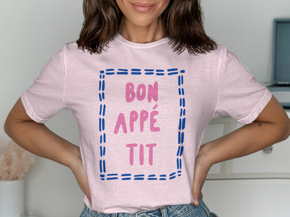 Pink t-shirt with "BON APPÉTIT" text in blue dashed border.