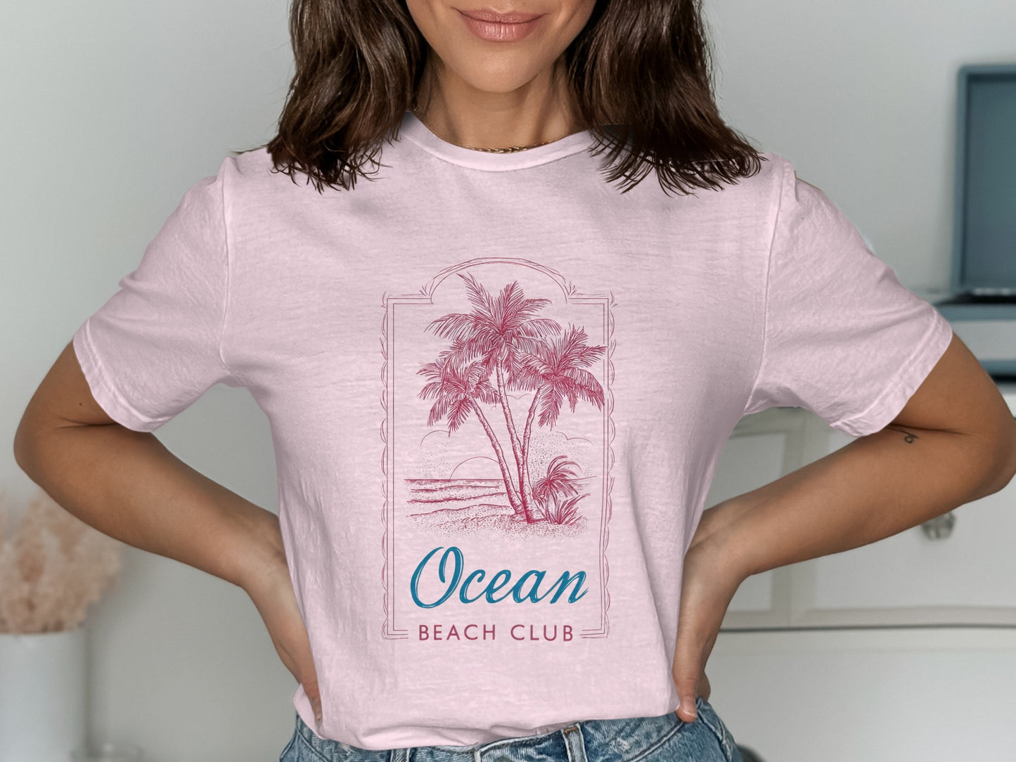 Pink t-shirt with "Ocean Beach Club" and palm trees graphic.