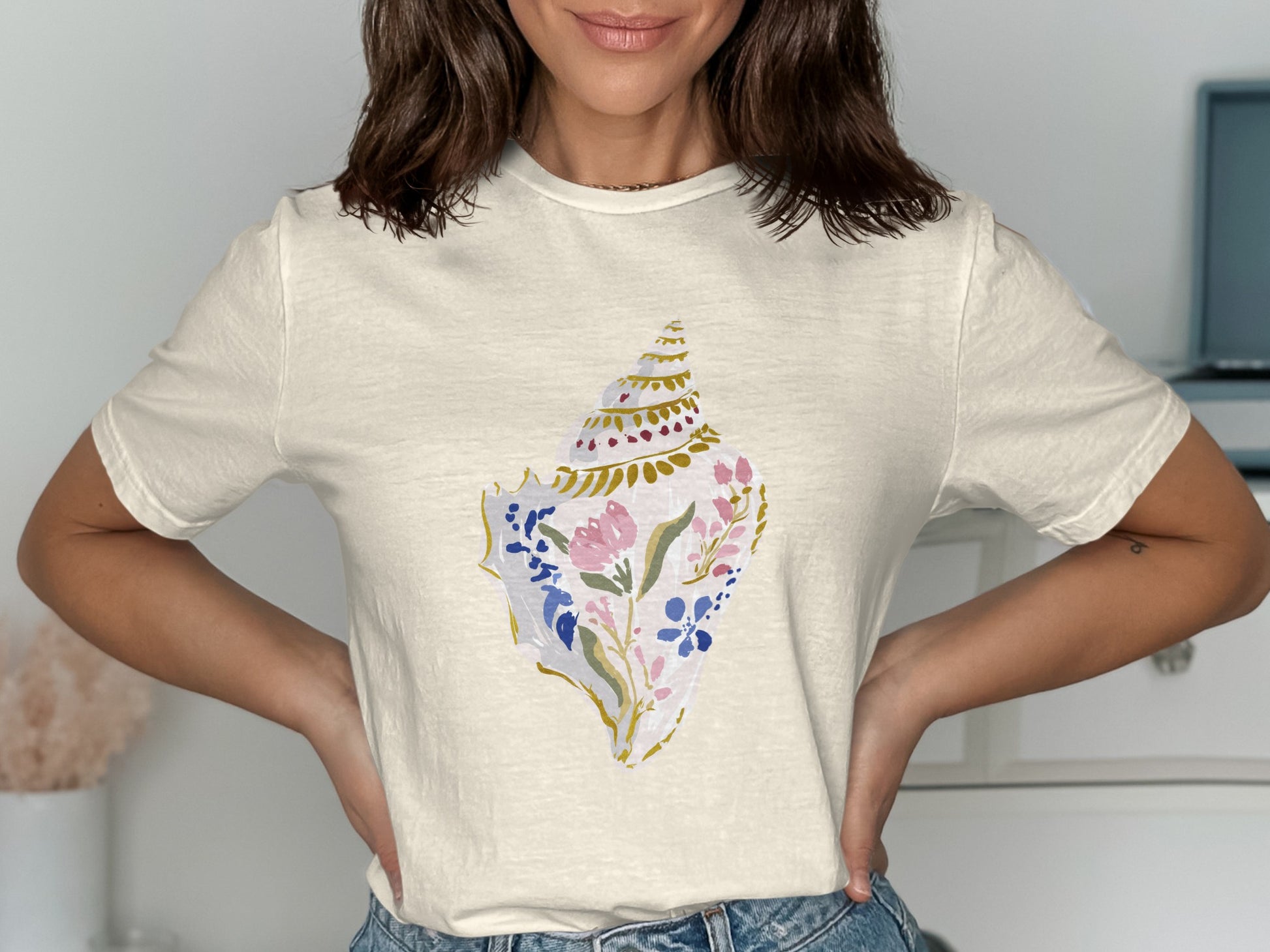 Cream t-shirt with a floral seashell graphic.