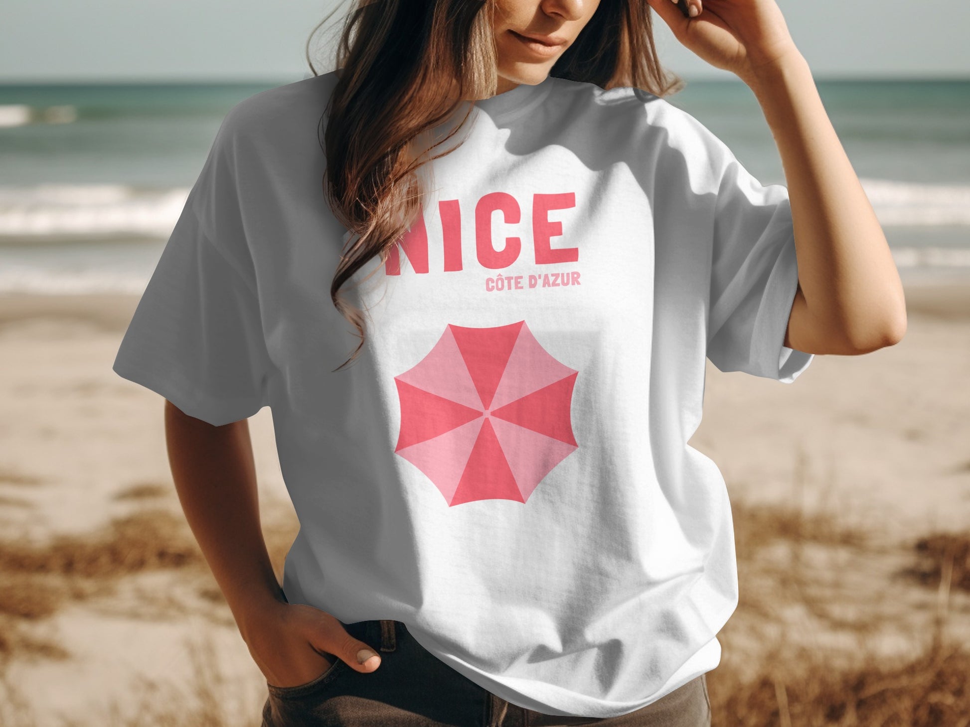 White t-shirt with "NICE CÔTE D'AZUR" and pink umbrella graphic.