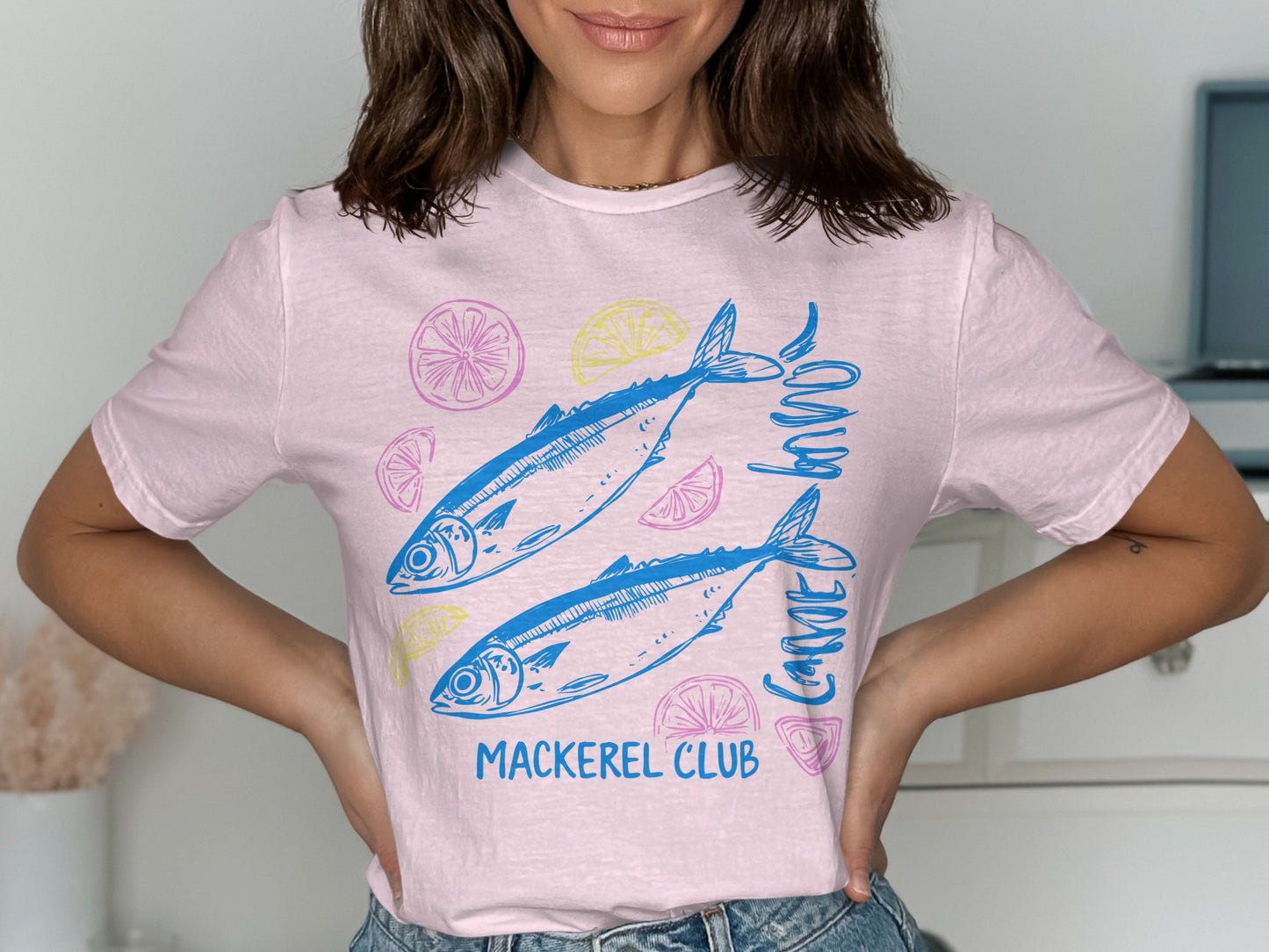 Pink t-shirt with two blue mackerel and sliced lemons, text "MACKEREL CLUB".
