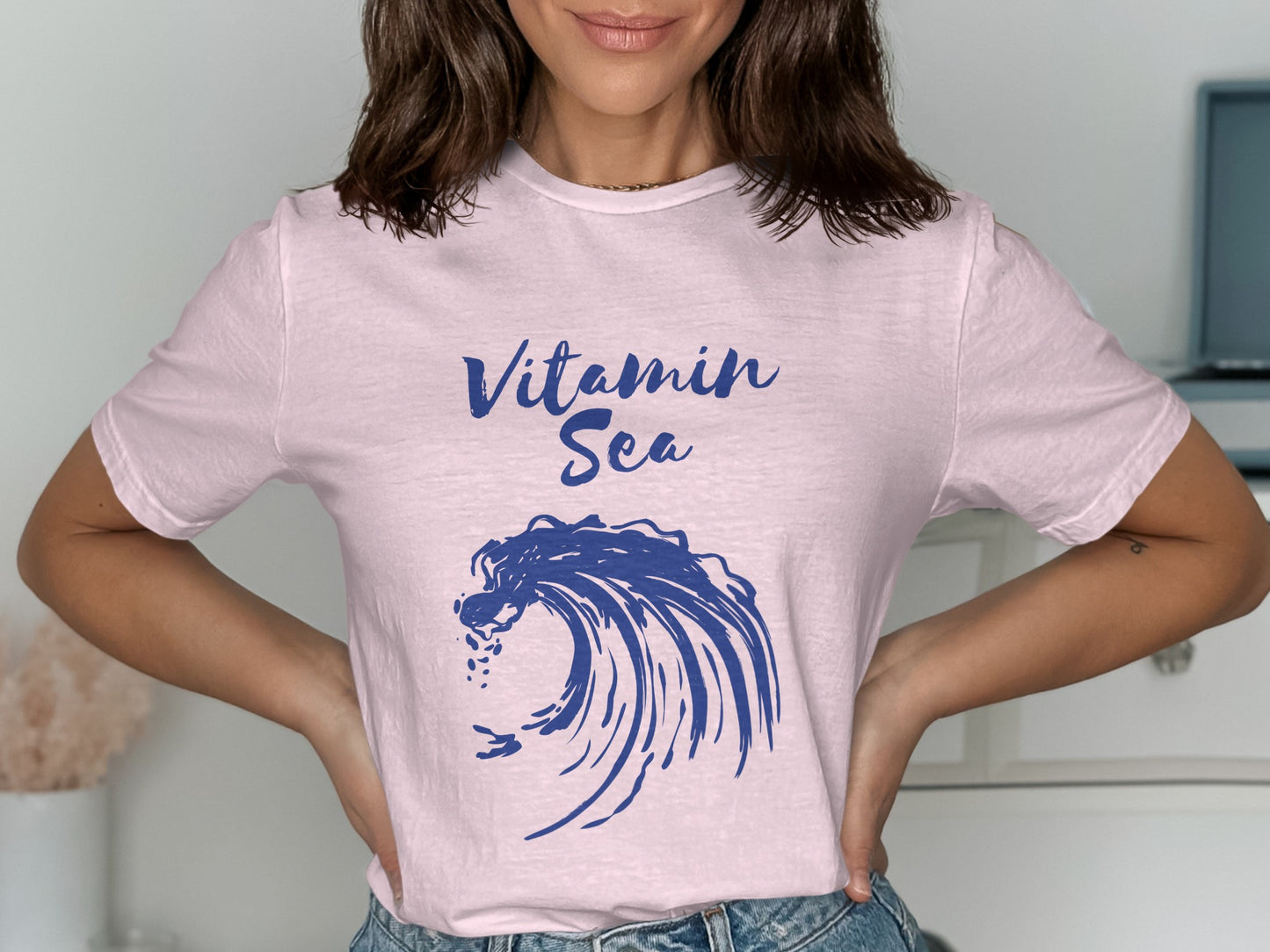 Pink t-shirt with a blue wave graphic and "Vitamin Sea" text.