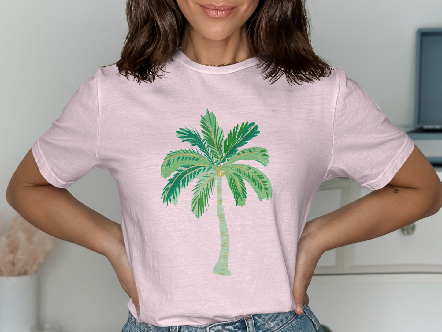 Pink t-shirt with watercolor palm tree graphic.