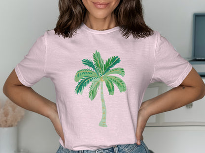 Pink t-shirt with watercolor palm tree graphic.