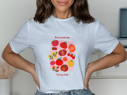 White t-shirt with illustration of various red tomatoes and text "Nuances de Tomates".