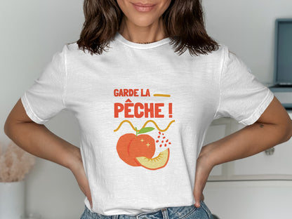 White t-shirt with "GARDE LA PÊCHE!" text and a peach illustration.