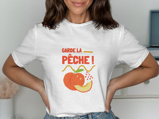 White t-shirt with "GARDE LA PÊCHE!" text and a peach illustration.