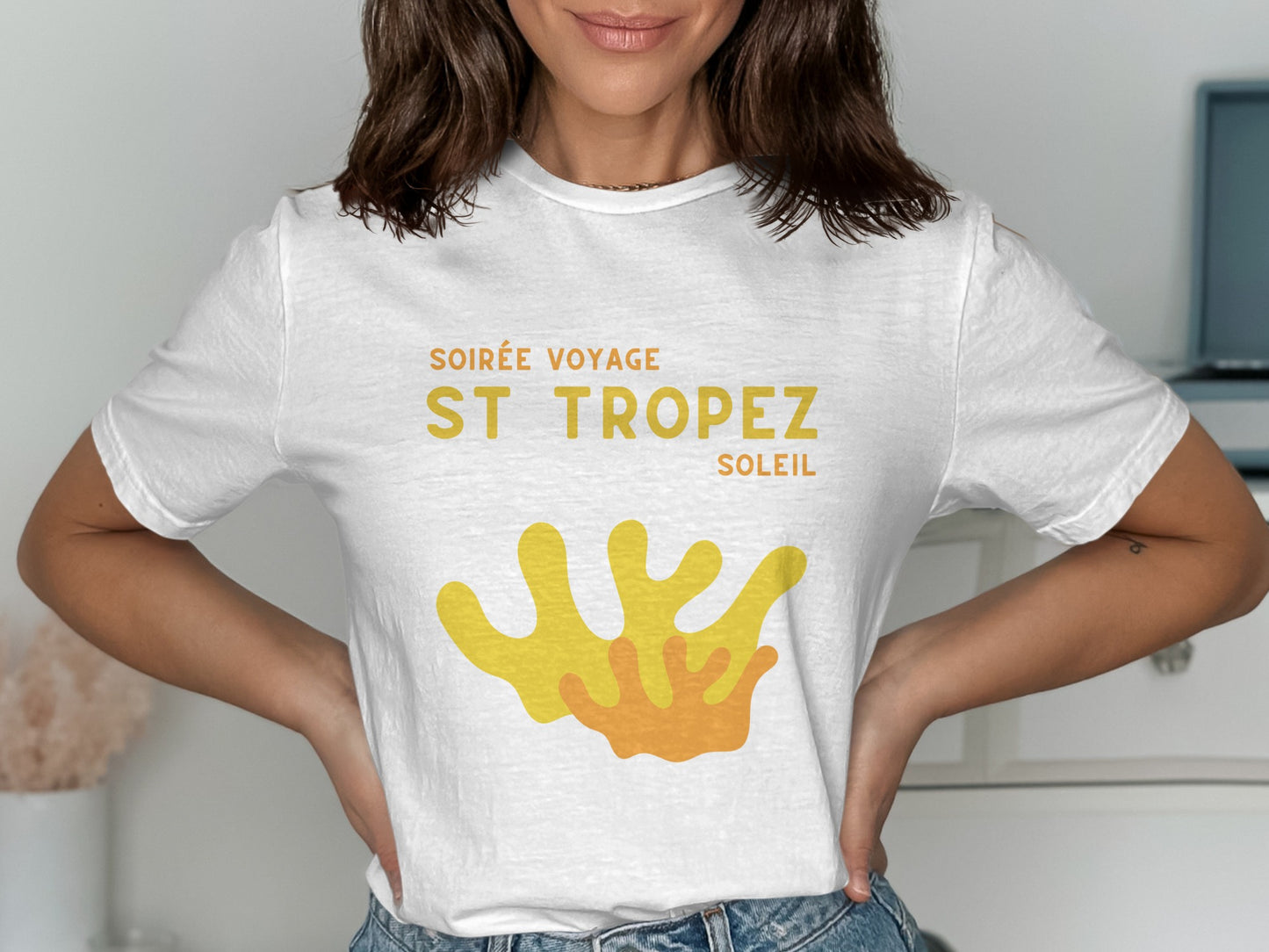 White t-shirt with "Soirée Voyage St. Tropez Soleil" and orange coral graphic.