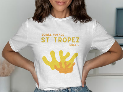 White t-shirt with "Soirée Voyage St. Tropez Soleil" and orange coral graphic.