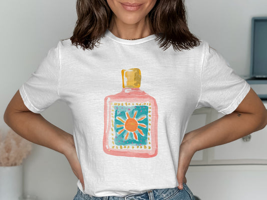 White t-shirt with watercolor illustration of a pink bottle and sun graphic.