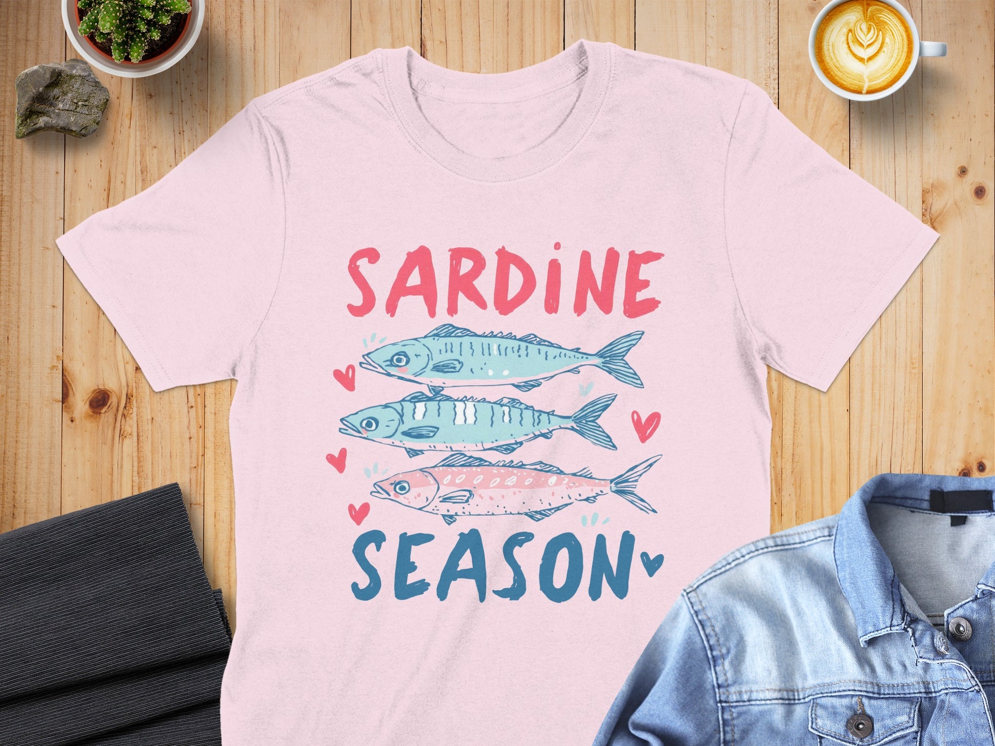 Pink t-shirt with "SARDINE SEASON" text and cartoon sardines.